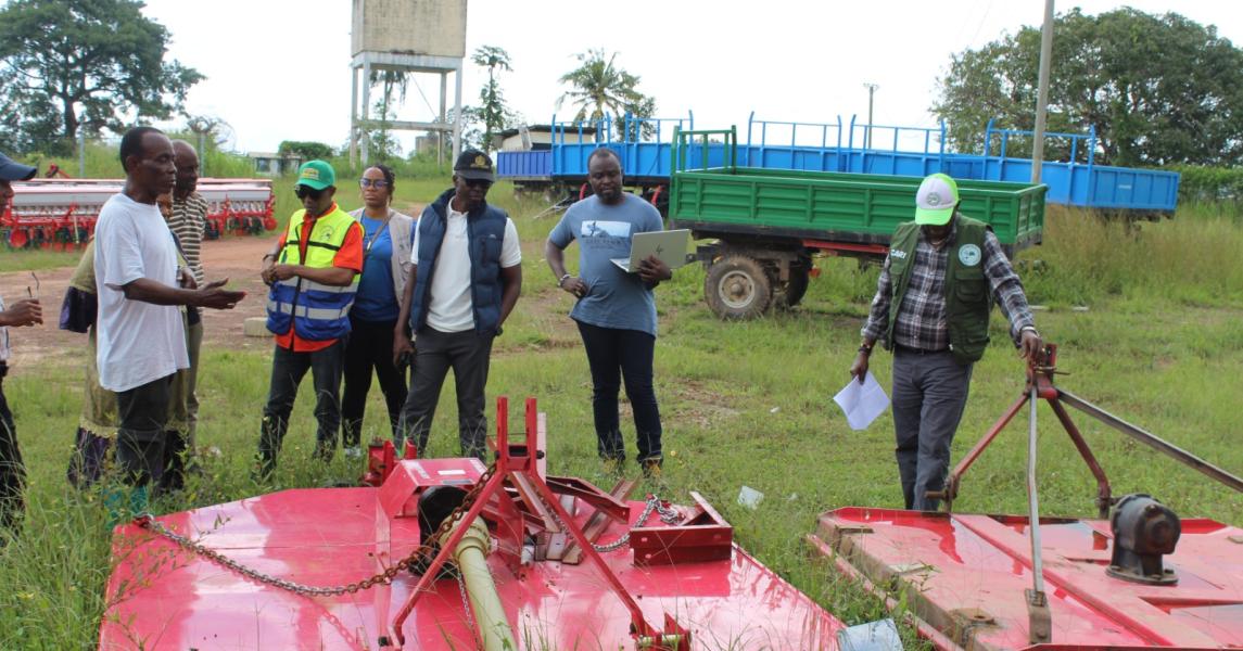 CARI Director General Dr. Arthur Bob Karnuah and his team inspect the bush hog implement, noting its function when mounted and attached to a tractor for effective grass cutting and field clearing.