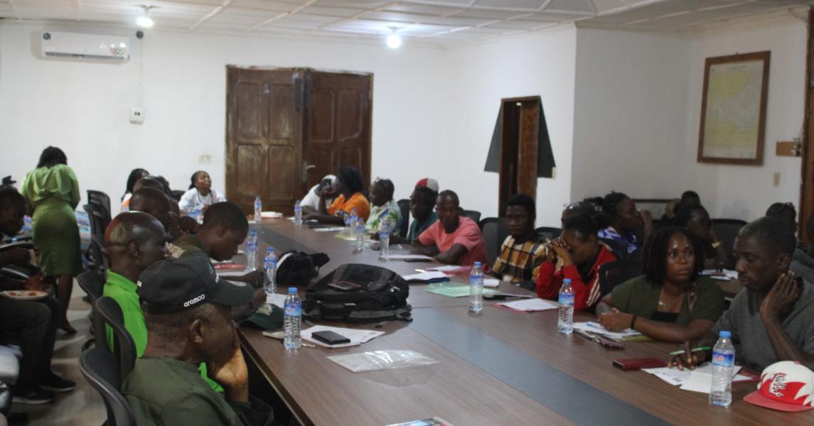 Participants listen attentively to a presentation by the facilitator during the aquaculture training workshop. The session highlights active engagement and shared learning as participants explore innovative approaches to fish farming and sustainable livelihoods in Liberia.