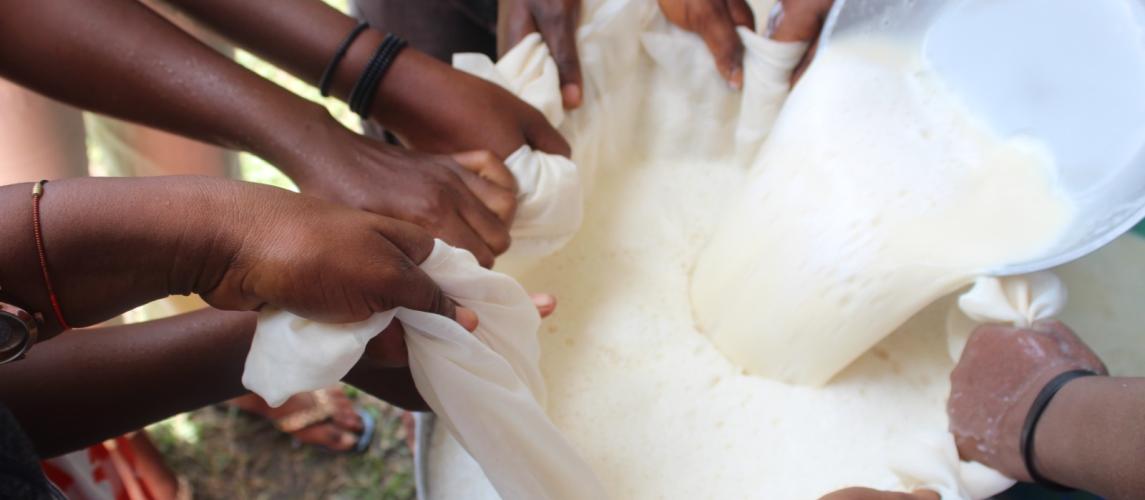 Farmers and students, working closely with the CARI nutritionist, carefully sieve freshly prepared soybean milk.